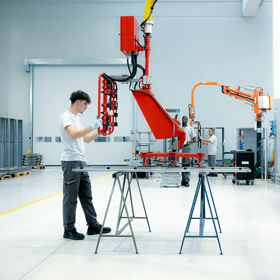 Operator using a robotic arm to retrieve steel sheets